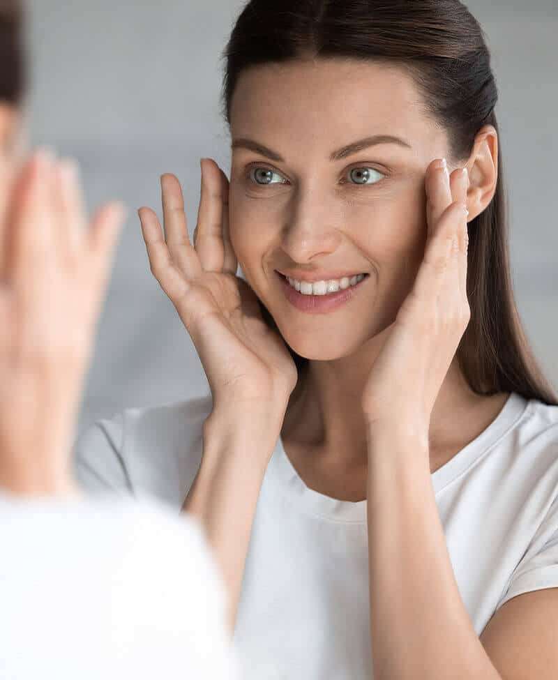 Woman looking at herself in the mirror