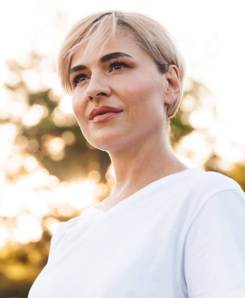 Mature woman out at sunset